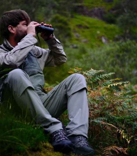 Man looking through a pair of binoculars